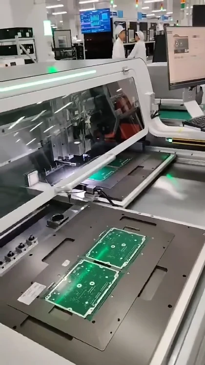 Green PCB panels on the two worktables of a JELIO router in the demonstration